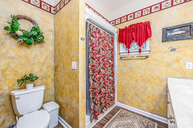 bathroom with toilet, hardwood / wood-style floors, a shower with shower curtain, vanity, and a textured ceiling