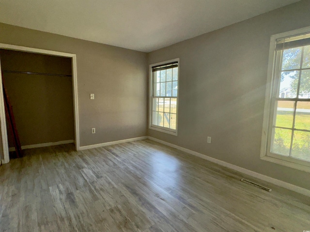 unfurnished bedroom featuring a closet and light wood-type flooring