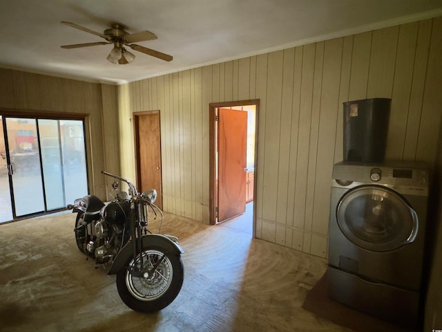 clothes washing area featuring ornamental molding, washer / clothes dryer, wooden walls, and ceiling fan