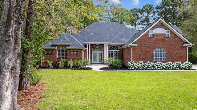 view of front of property with french doors and a front lawn