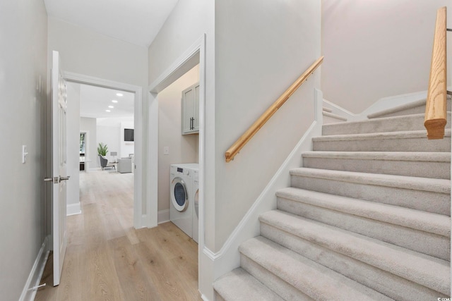 interior space featuring cabinets, light hardwood / wood-style flooring, and washer / clothes dryer