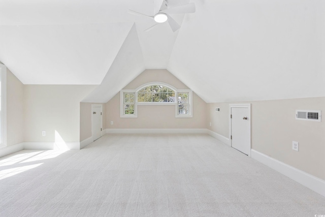 bonus room with ceiling fan, lofted ceiling, and light colored carpet