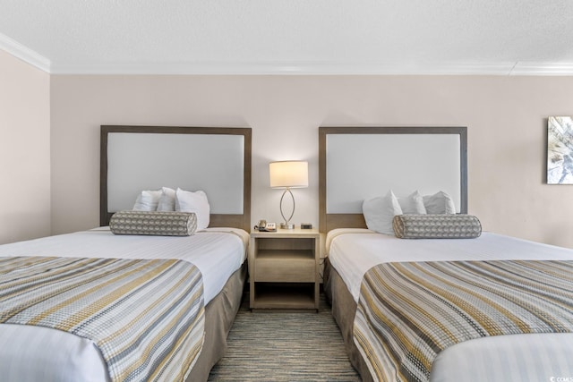 bedroom with crown molding and a textured ceiling