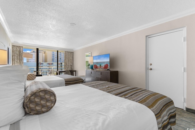 bedroom with access to outside, crown molding, a textured ceiling, and floor to ceiling windows