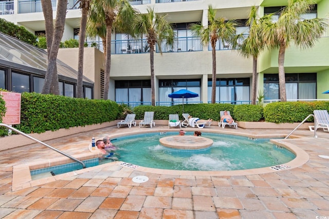 view of pool with a patio and a jacuzzi