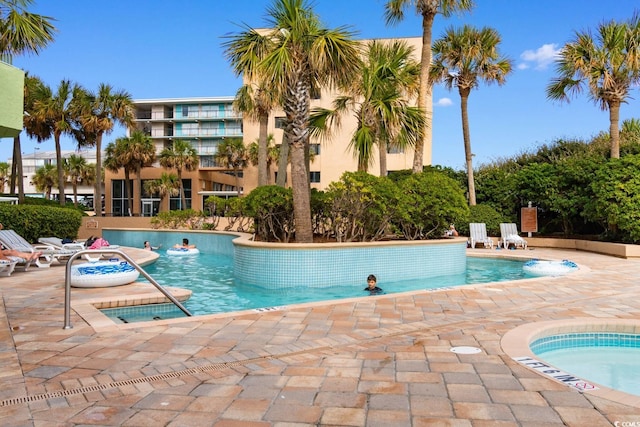 view of swimming pool with a patio area and a jacuzzi