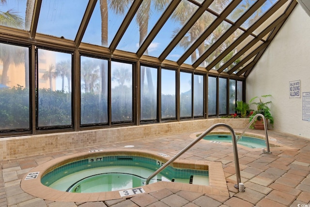 view of swimming pool with an indoor hot tub