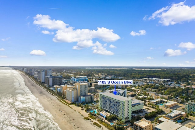 drone / aerial view with a water view and a beach view