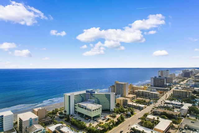 drone / aerial view featuring a water view and a view of the beach