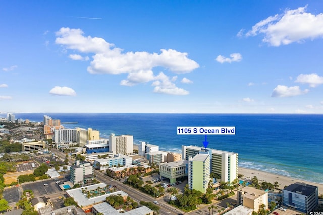 bird's eye view with a water view and a beach view