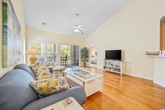 living room featuring wood-type flooring, high vaulted ceiling, and ceiling fan