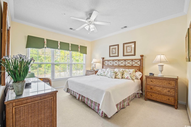 bedroom with ornamental molding, carpet flooring, and a textured ceiling