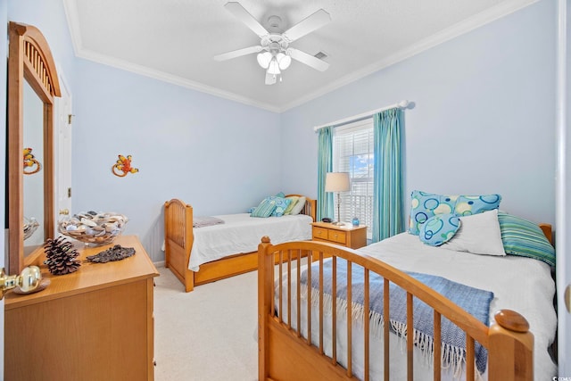 bedroom with crown molding, ceiling fan, and carpet floors