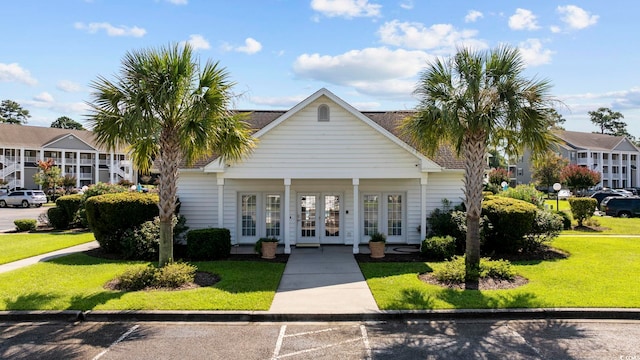 view of front of property featuring a front lawn and french doors