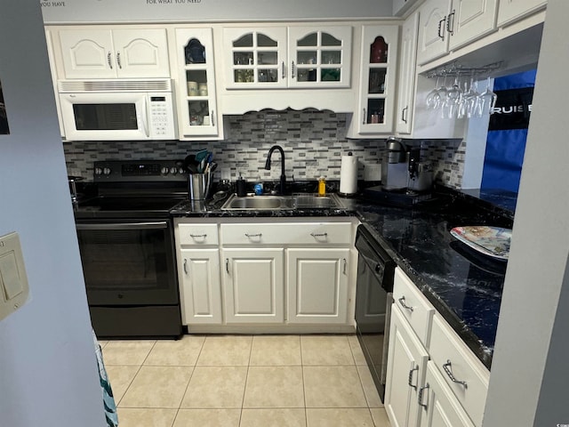 kitchen featuring decorative backsplash, white cabinetry, black appliances, and sink