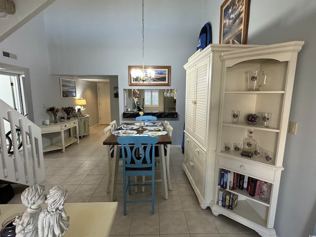 tiled dining room with high vaulted ceiling, a wealth of natural light, and a chandelier