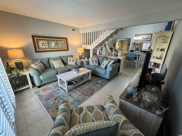 tiled living room featuring a notable chandelier