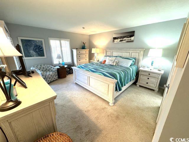 bedroom featuring light carpet