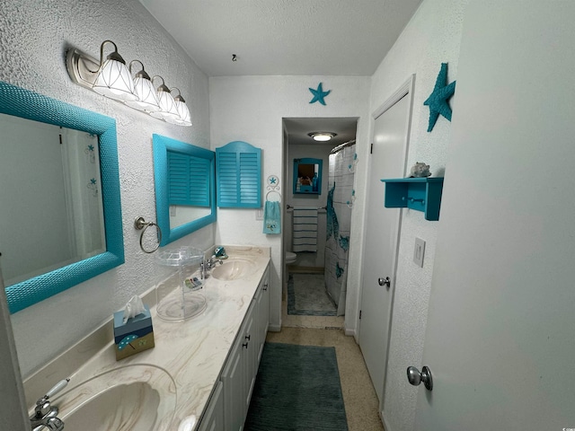 bathroom featuring vanity, a textured ceiling, toilet, and walk in shower