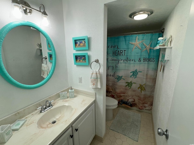 bathroom featuring vanity, a shower with curtain, toilet, and tile patterned floors