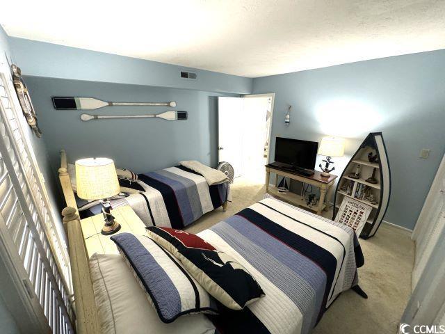 bedroom featuring light colored carpet