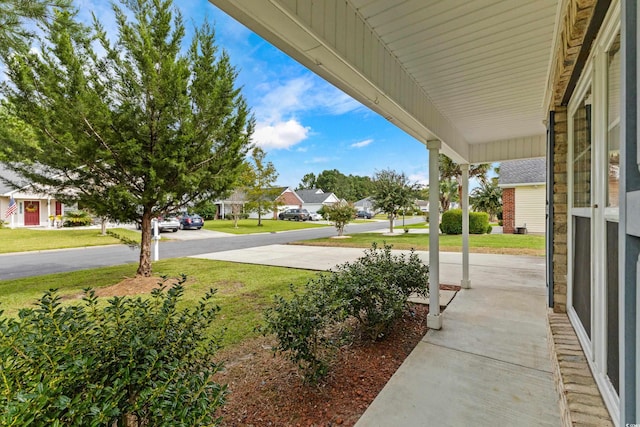 view of yard featuring covered porch