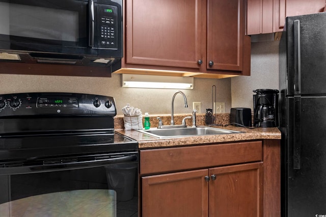 kitchen with sink, decorative backsplash, and black appliances