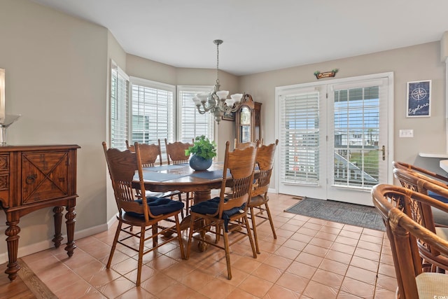 dining space featuring a notable chandelier and light tile patterned floors