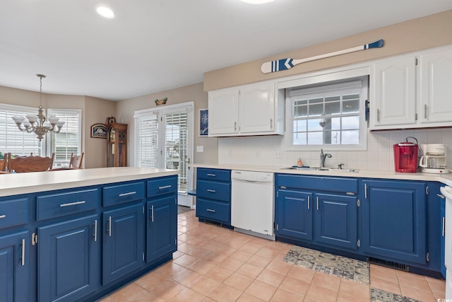 kitchen with decorative light fixtures, an inviting chandelier, sink, white cabinets, and dishwasher