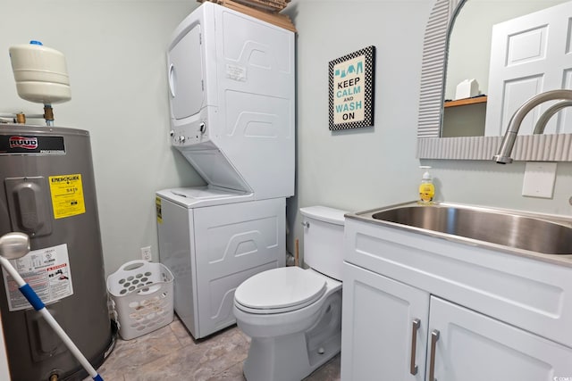 bathroom with electric water heater, stacked washing maching and dryer, sink, and toilet