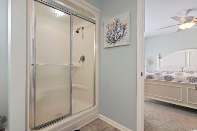 bathroom with an enclosed shower and ceiling fan