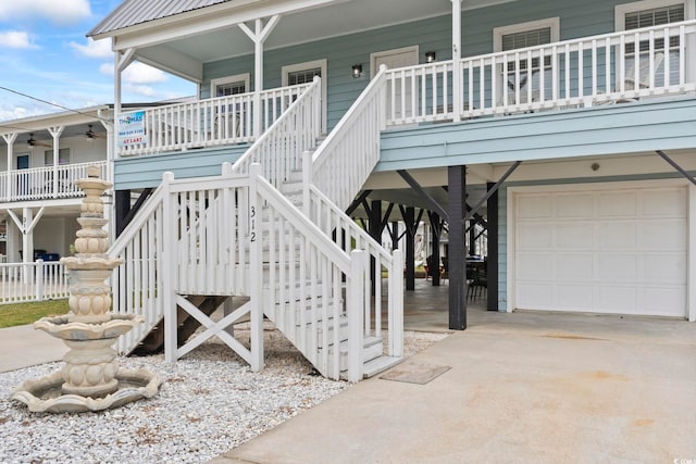 property entrance with a garage and ceiling fan