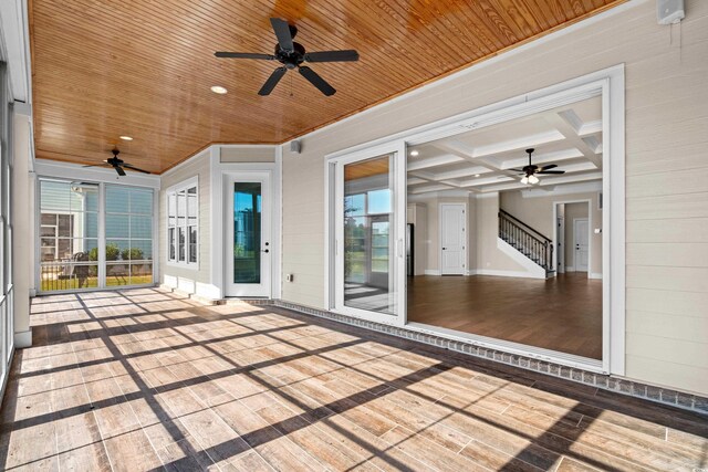 unfurnished sunroom featuring beam ceiling, wood ceiling, and coffered ceiling