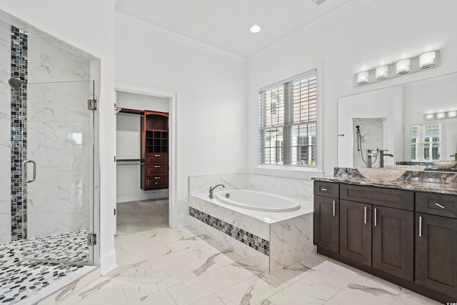 bathroom featuring vanity, ornamental molding, and separate shower and tub