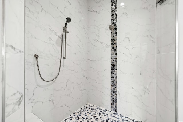 bathroom with tiled shower