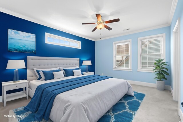 carpeted bedroom featuring ceiling fan and ornamental molding