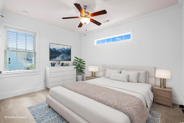 carpeted bedroom featuring ceiling fan and crown molding