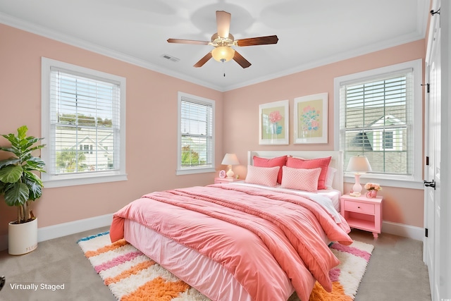 carpeted bedroom featuring ceiling fan and crown molding