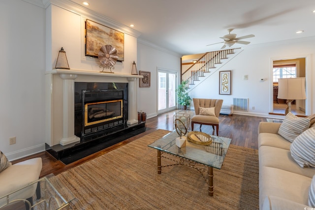 living room featuring crown molding, ceiling fan, and dark hardwood / wood-style flooring