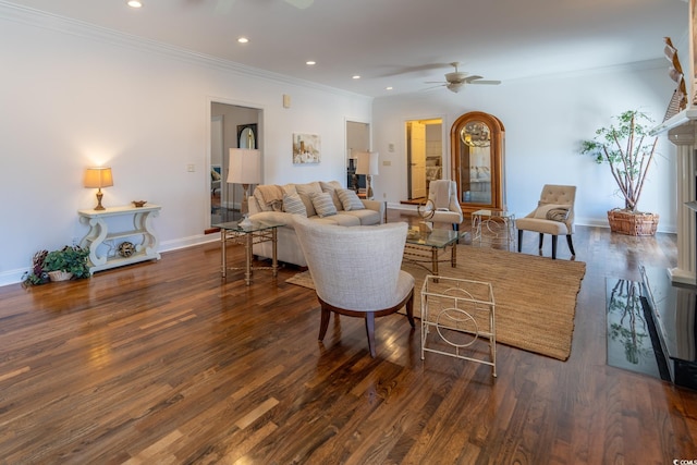 living room featuring ornamental molding, dark wood-type flooring, and ceiling fan