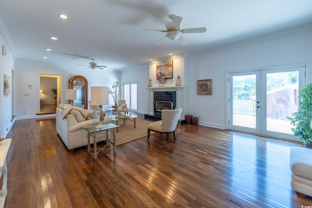 living room with crown molding, dark wood-type flooring, and ceiling fan