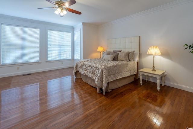 bedroom featuring crown molding, wood-type flooring, and ceiling fan