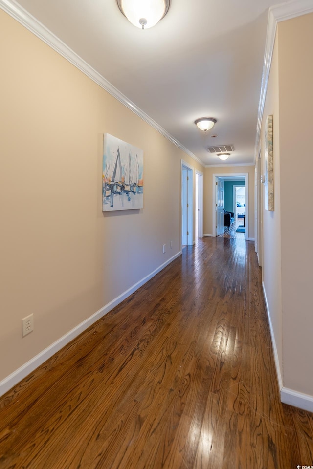 hall featuring crown molding and dark hardwood / wood-style floors