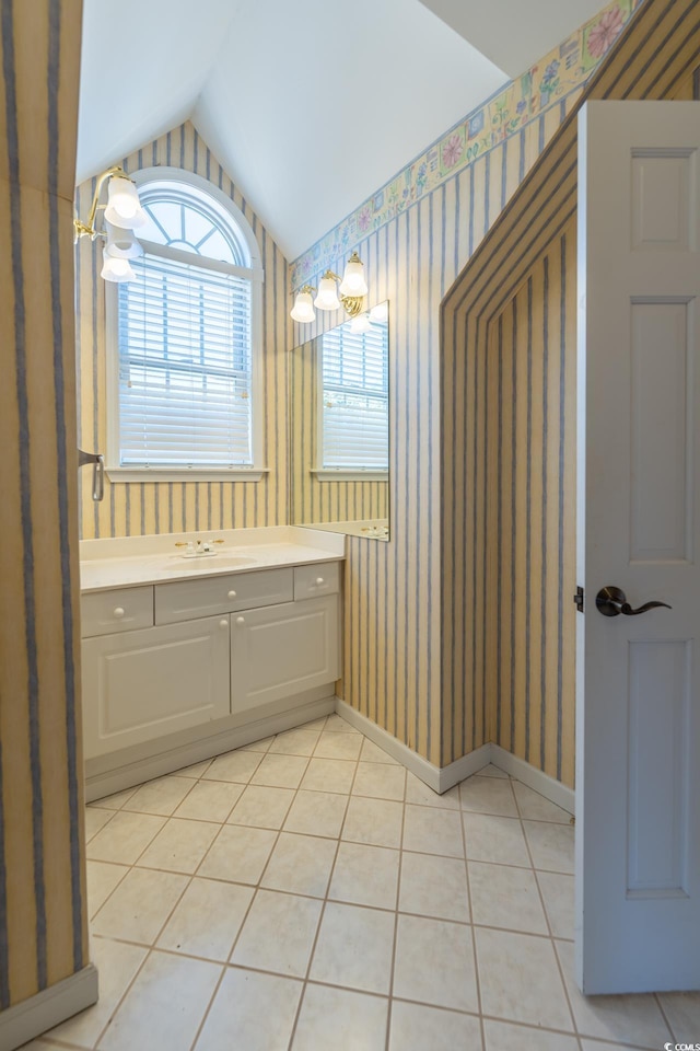 bathroom with vanity, lofted ceiling, and tile patterned floors