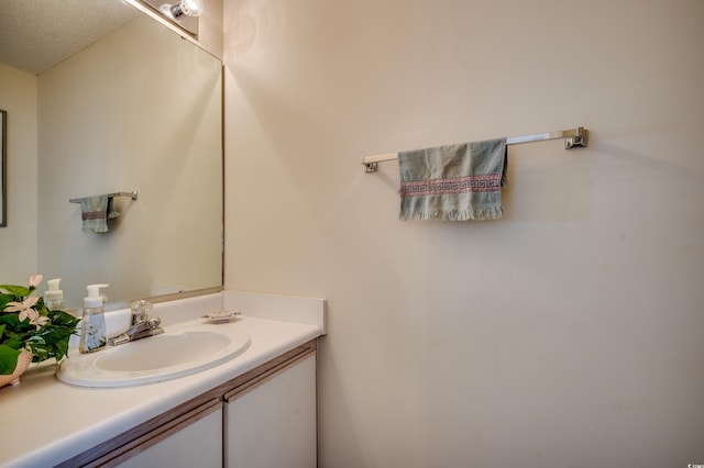 bathroom featuring vanity and a textured ceiling