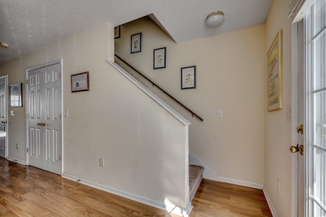 foyer featuring light hardwood / wood-style floors and a textured ceiling