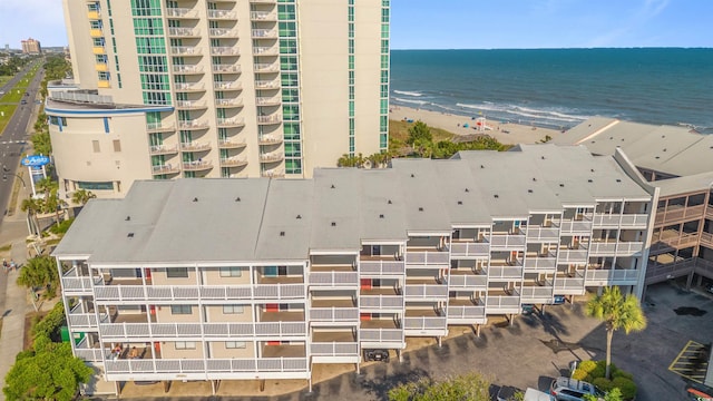 drone / aerial view featuring a water view and a beach view