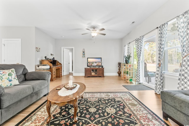 living room featuring light hardwood / wood-style flooring and ceiling fan