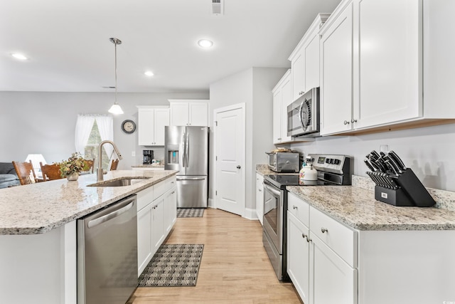 kitchen featuring white cabinetry, light hardwood / wood-style floors, and stainless steel appliances