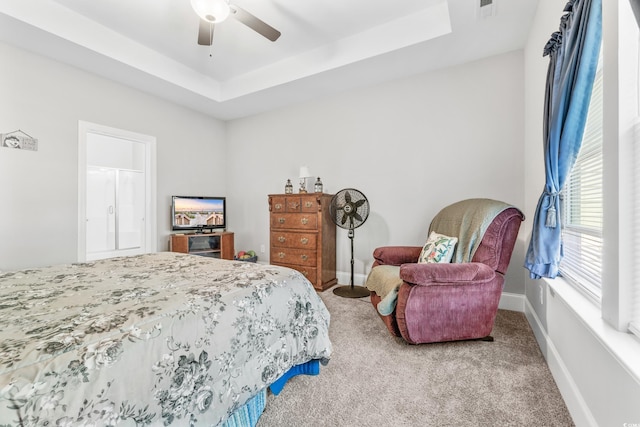 bedroom with a tray ceiling, carpet, and ceiling fan